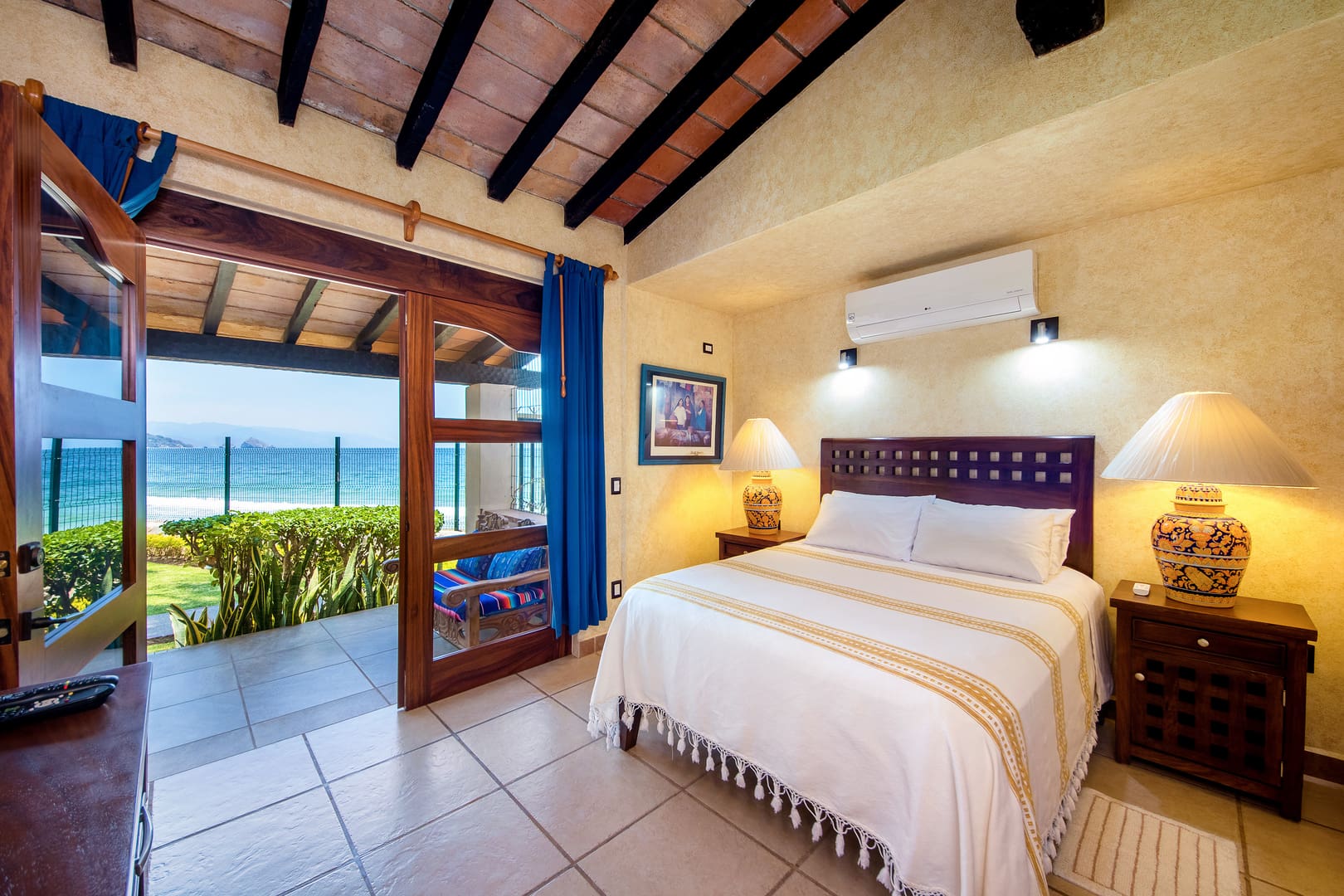 a bedroom with a view of the beach